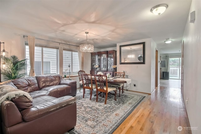 dining space featuring a chandelier and light wood-type flooring