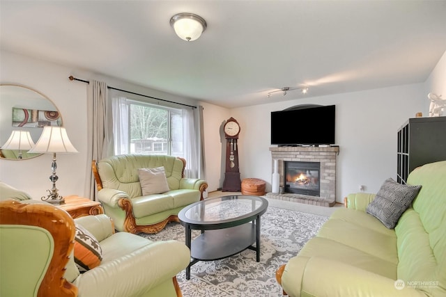 living room with a brick fireplace