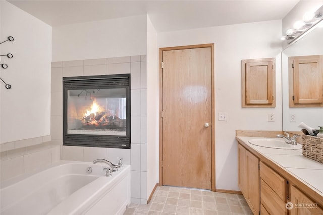 bathroom with vanity and a bath