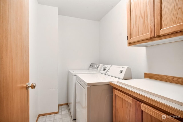 laundry room featuring cabinets and separate washer and dryer