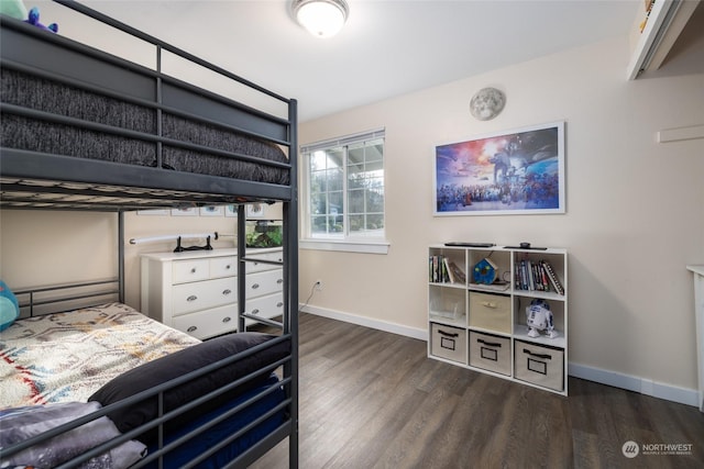 bedroom with dark hardwood / wood-style flooring