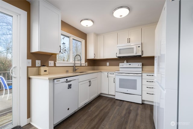 kitchen with sink, white appliances, white cabinetry, and dark hardwood / wood-style floors