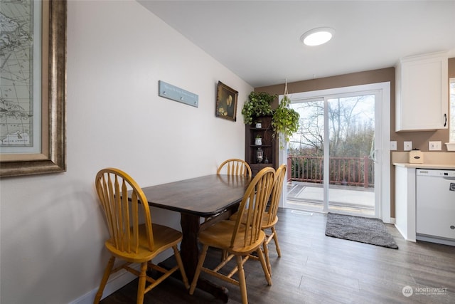 dining space with wood-type flooring