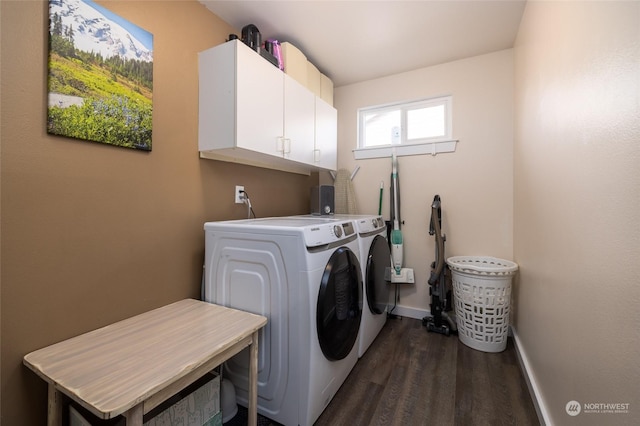 laundry area featuring dark hardwood / wood-style flooring, cabinets, and washer and clothes dryer