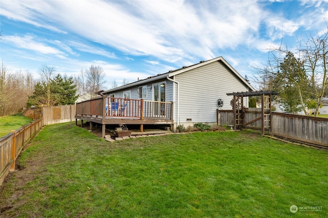 back of property featuring a lawn, a deck, and a pergola