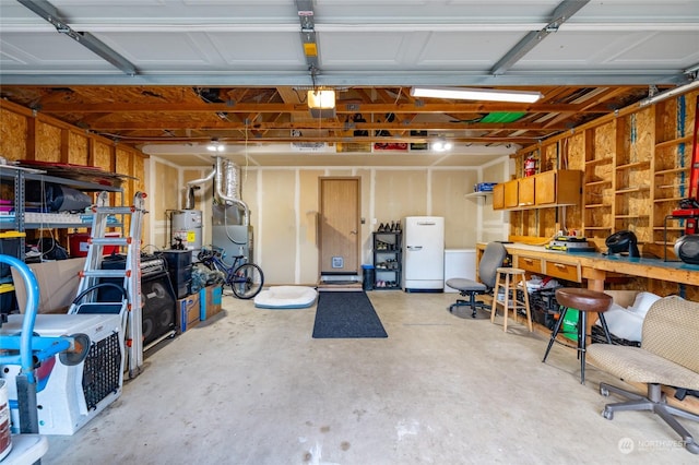 garage featuring a workshop area, water heater, and a garage door opener