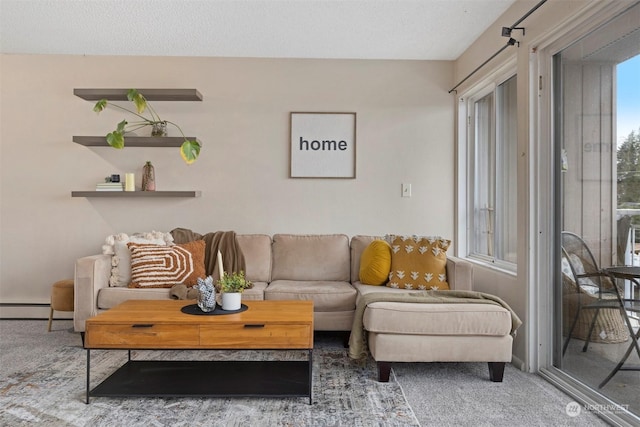 carpeted living room with baseboard heating