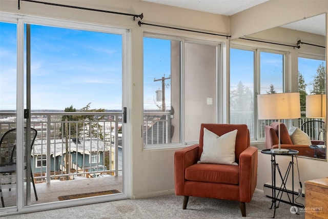 sunroom featuring baseboard heating and a healthy amount of sunlight