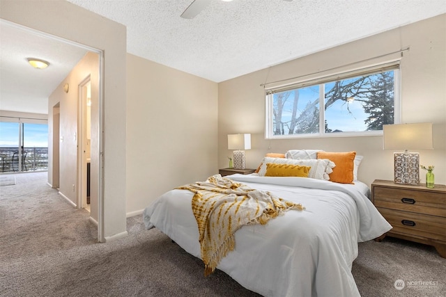 carpeted bedroom featuring ceiling fan, access to exterior, and a textured ceiling