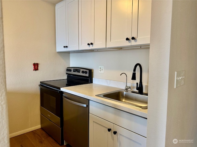 kitchen with sink, white cabinets, stainless steel appliances, and dark hardwood / wood-style floors