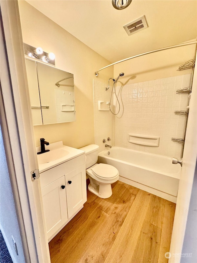 full bathroom featuring shower / bathing tub combination, vanity, toilet, and wood-type flooring