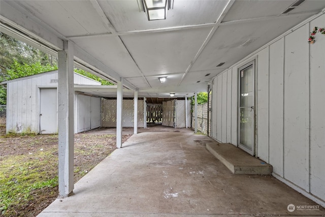 view of patio / terrace featuring a carport and a storage shed