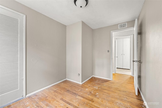 unfurnished bedroom featuring a closet and light hardwood / wood-style floors