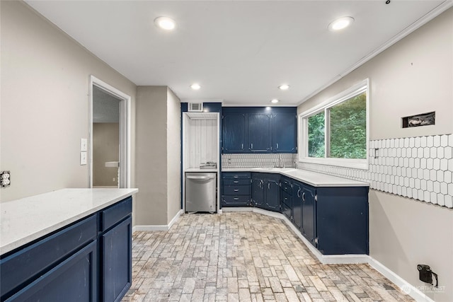 kitchen featuring dishwasher, blue cabinets, ornamental molding, and tasteful backsplash