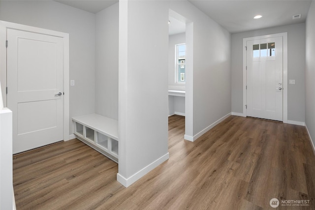 foyer entrance with recessed lighting, baseboards, and wood finished floors