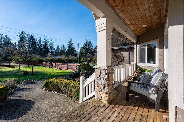 wooden deck featuring a yard