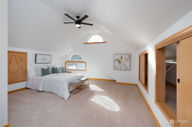 carpeted bedroom featuring lofted ceiling and ceiling fan