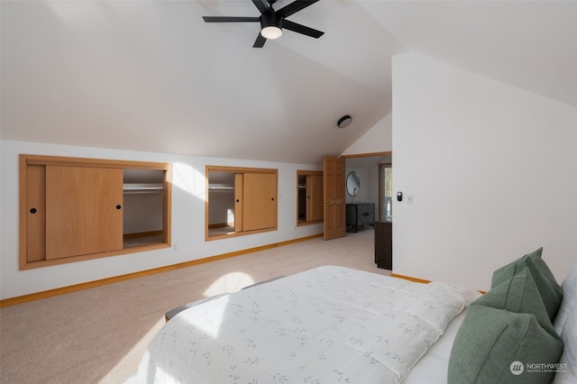 bedroom featuring ceiling fan, light colored carpet, and vaulted ceiling