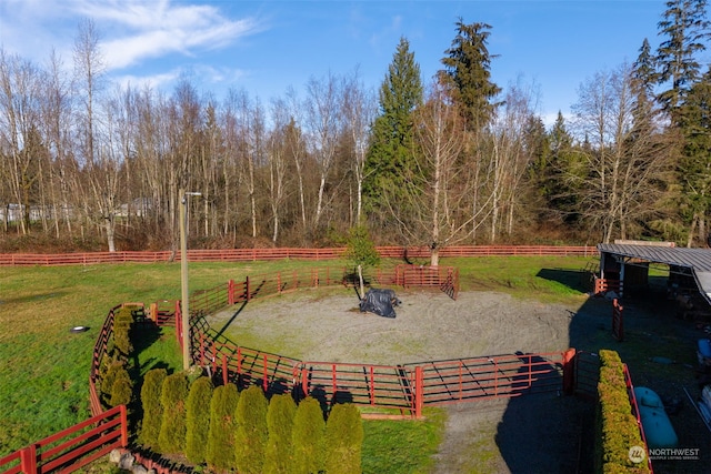 view of yard featuring a rural view and an outdoor structure