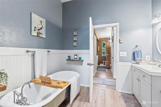 bathroom featuring a bathtub, vanity, and hardwood / wood-style flooring