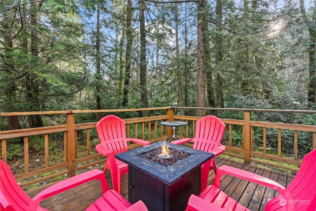 wooden deck featuring a fire pit