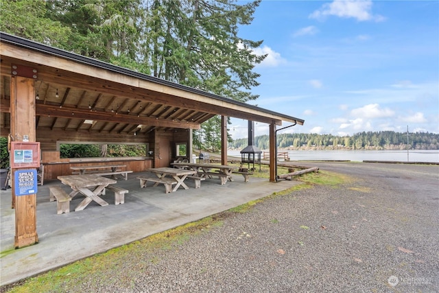 surrounding community featuring a water view and a gazebo