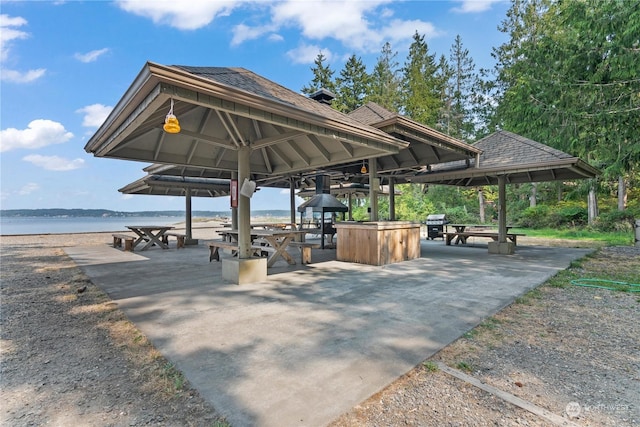 surrounding community featuring a water view, a patio area, and a gazebo