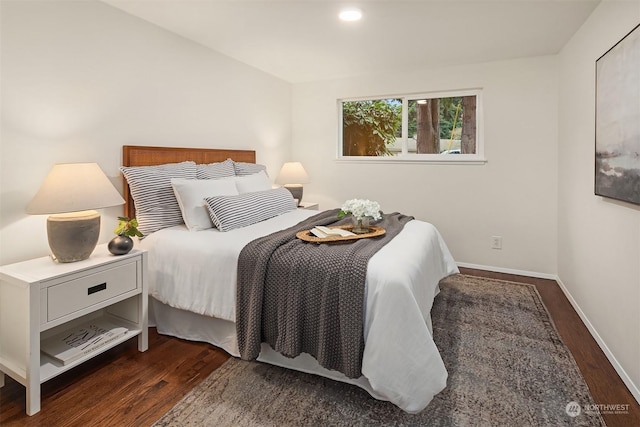 bedroom with dark wood-type flooring