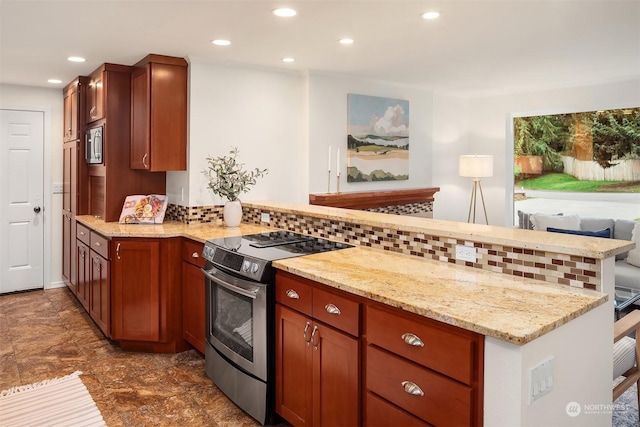 kitchen featuring kitchen peninsula, stainless steel appliances, light stone countertops, and decorative backsplash