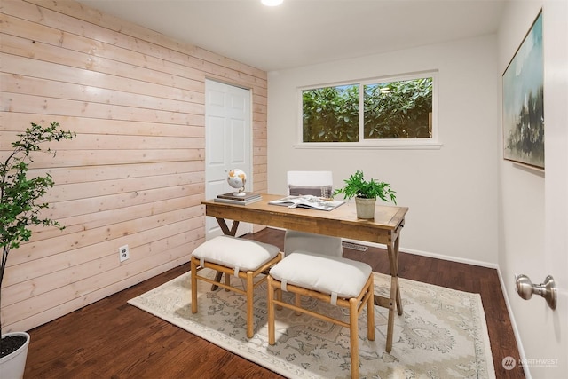 office area featuring dark hardwood / wood-style flooring and wooden walls