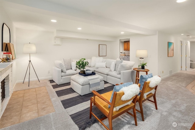 living room featuring light colored carpet and a fireplace