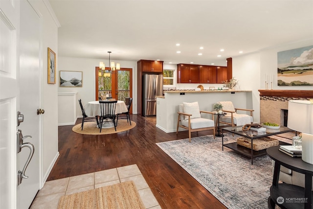 tiled living room featuring a notable chandelier