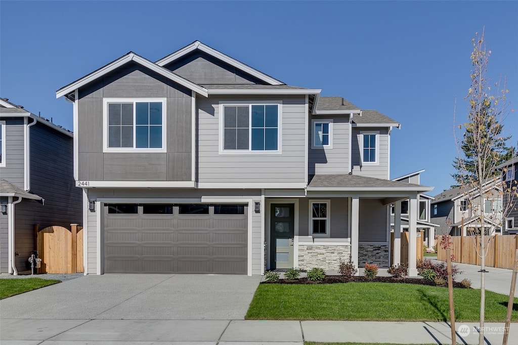 view of front of property with a front yard and a garage