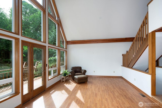 8917 SE Mcbreen Ln, Port Orchard, WA 98367 - unfurnished room featuring high vaulted ceiling, light wood-style floors, french doors, and stairway