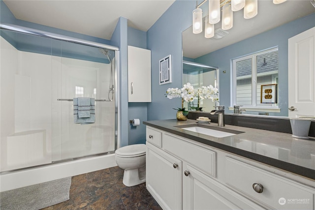 bathroom with an enclosed shower, vanity, and toilet