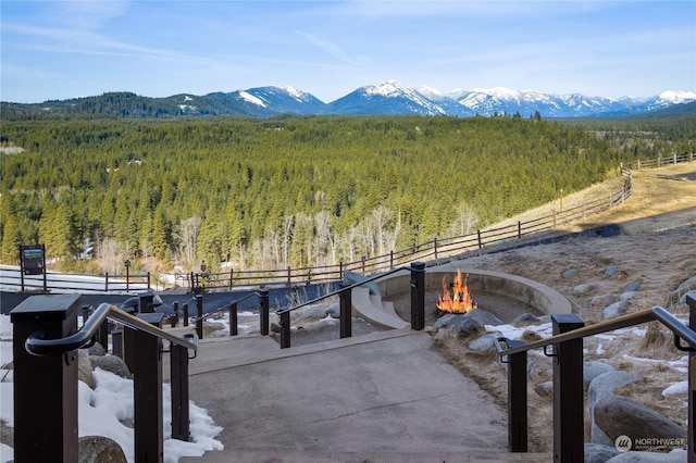 surrounding community featuring a fire pit and a mountain view