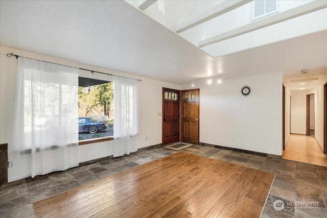 entrance foyer featuring track lighting and a textured ceiling