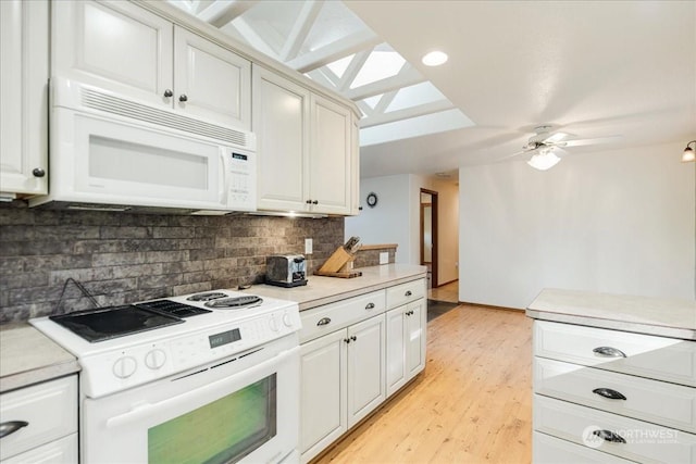 kitchen featuring white cabinetry, white appliances, and decorative backsplash