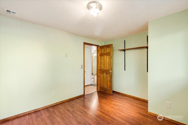 unfurnished bedroom with wood-type flooring