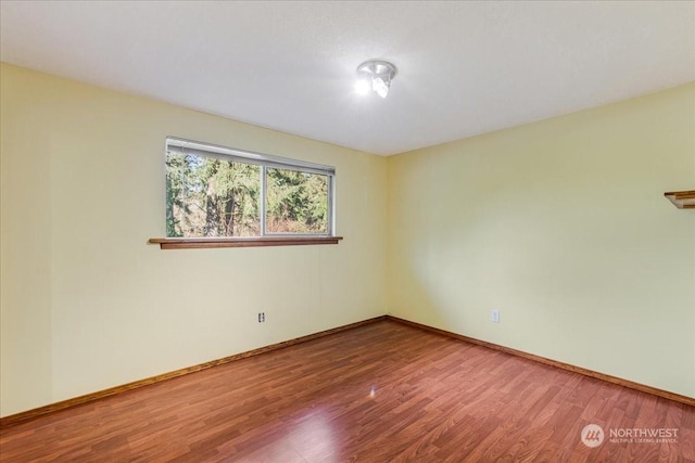 unfurnished room with wood-type flooring