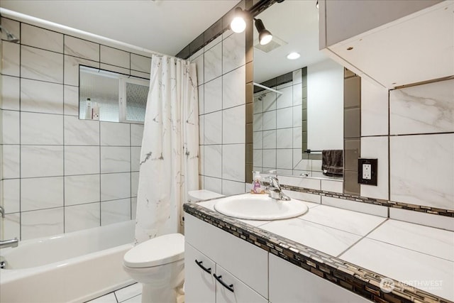 full bathroom featuring tile walls, shower / tub combo, tile patterned flooring, vanity, and toilet