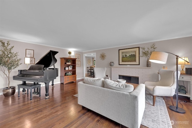 living room featuring a fireplace, crown molding, and dark wood-type flooring