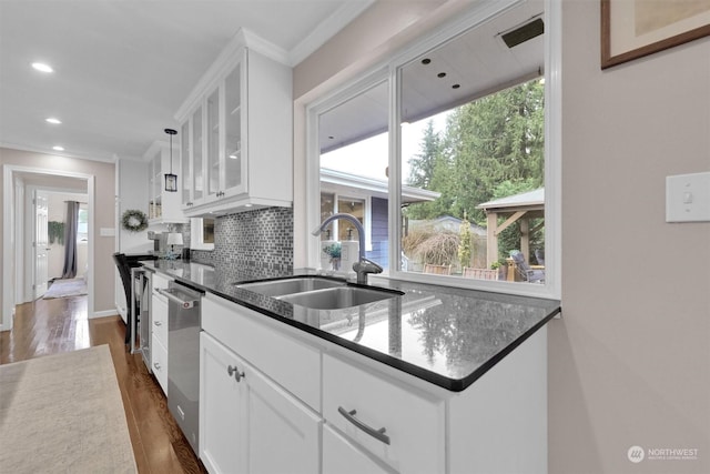 kitchen featuring white cabinets, dishwasher, dark hardwood / wood-style flooring, sink, and backsplash