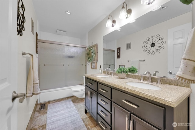 full bathroom with toilet, enclosed tub / shower combo, and vanity