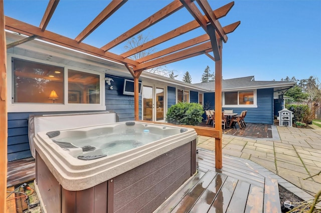 wooden deck with a patio, a hot tub, and a pergola