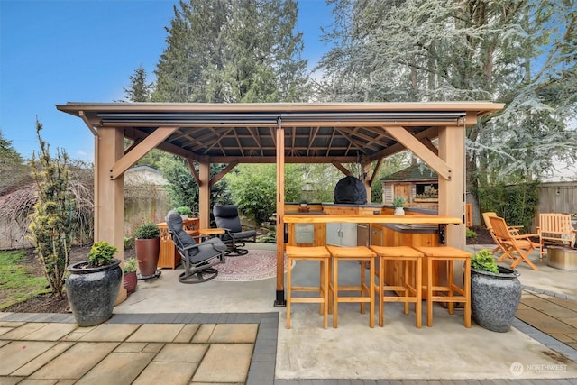 view of patio with exterior bar and a gazebo