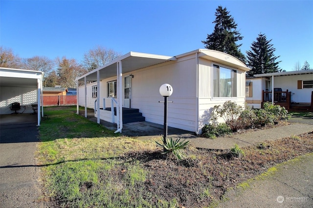 view of property exterior featuring a lawn and a carport