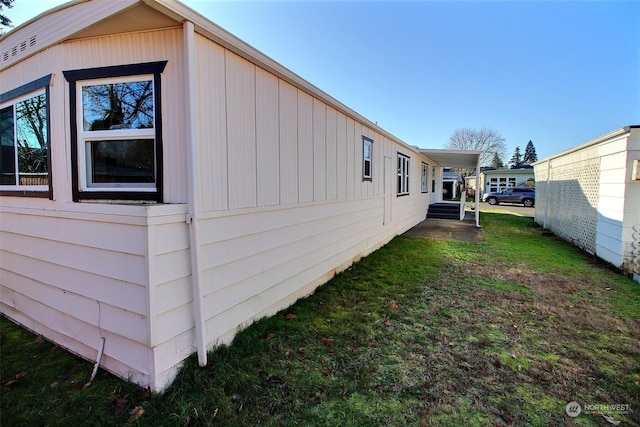 view of side of property with a yard