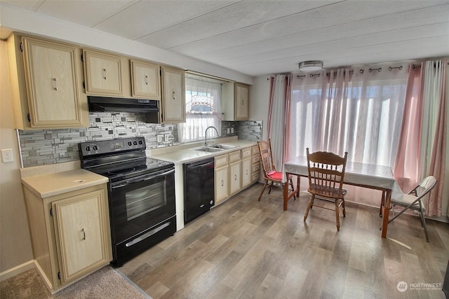 kitchen with sink, light hardwood / wood-style floors, decorative backsplash, light brown cabinetry, and black appliances