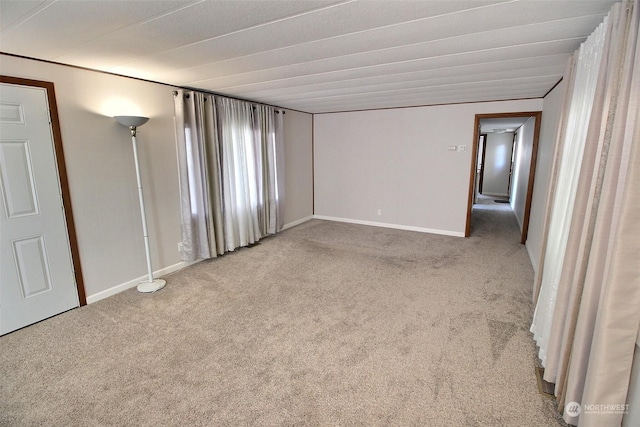 unfurnished room featuring light colored carpet